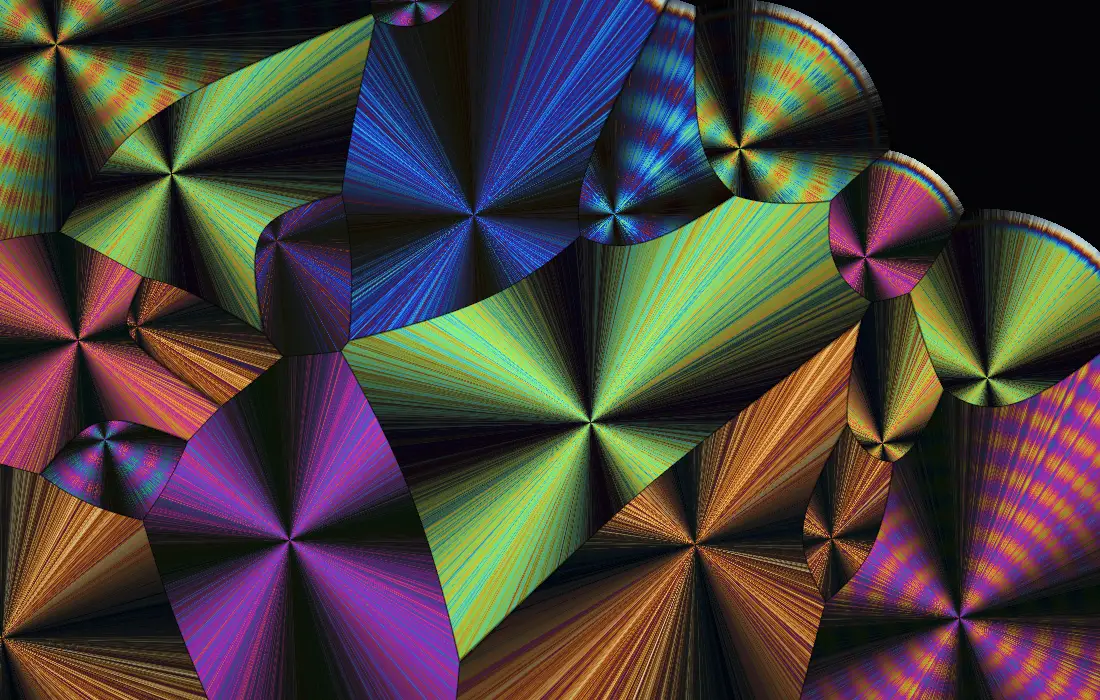 Crystals seen between polarizing filters: fans of needles in orange, violet, teal and pink meeting along straight borders.